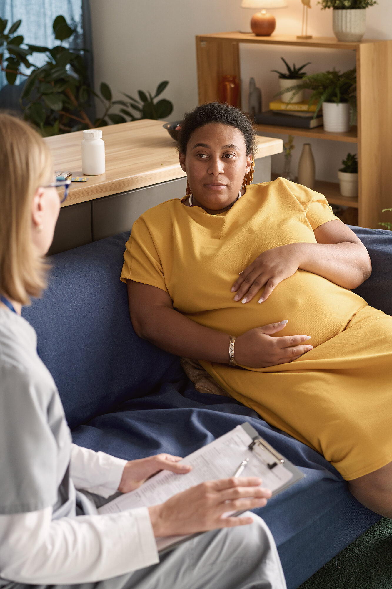 Pregnant woman speaking with a clinician about perinatal care